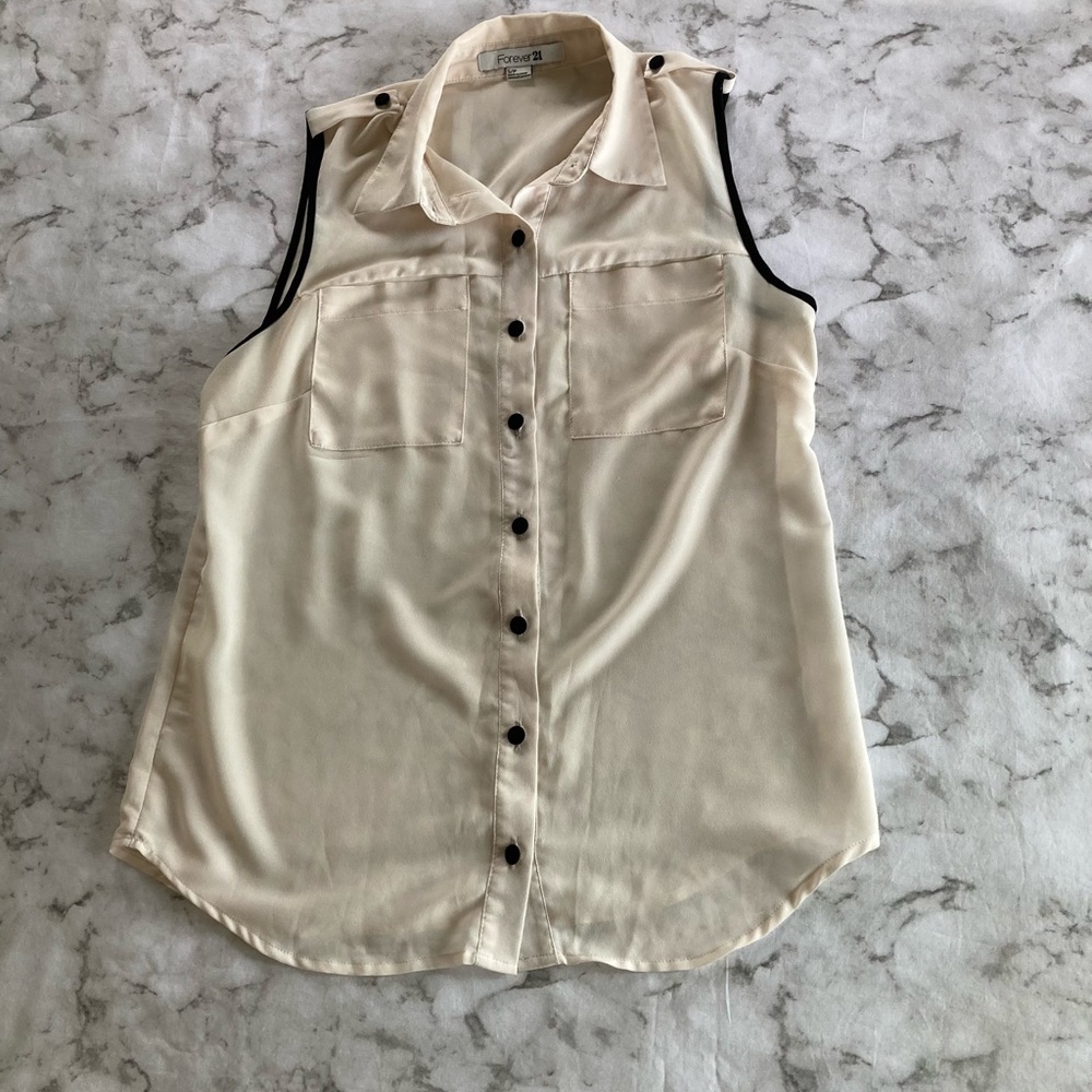 Creme and black sleeveless blouse
